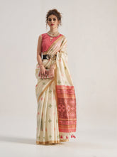 Elegant beige Patola silk saree featuring intricate geometric and floral weaving patterns. Includes a matching blouse piece. Ideal for festive and ceremonial occasions.