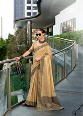 Woman in a beige saree standing on a modern balcony with a cityscape background
