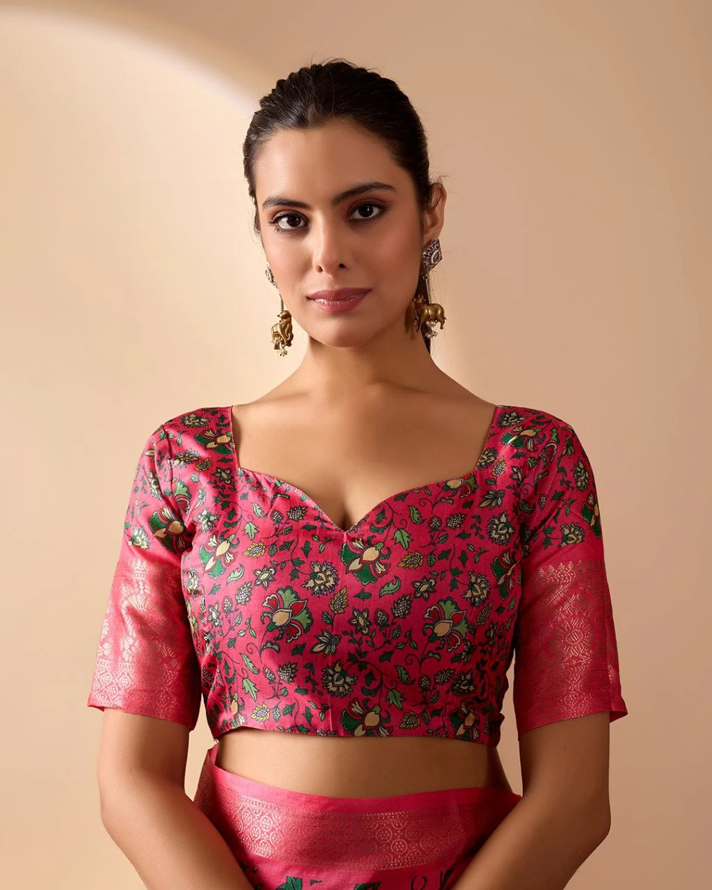 Woman wearing a pink traditional outfit with a floral blouse on a beige background