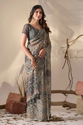 Woman wearing a gray saree with a subtle pattern against a neutral background