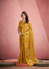 Woman wearing a yellow saree with a pink background