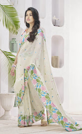 Woman wearing a floral saree in a white room with plants