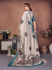 Woman wearing a traditional saree with intricate patterns in a decorated indoor setting