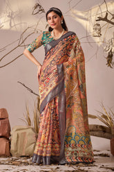 Woman wearing a traditional saree with a patterned design against a neutral background