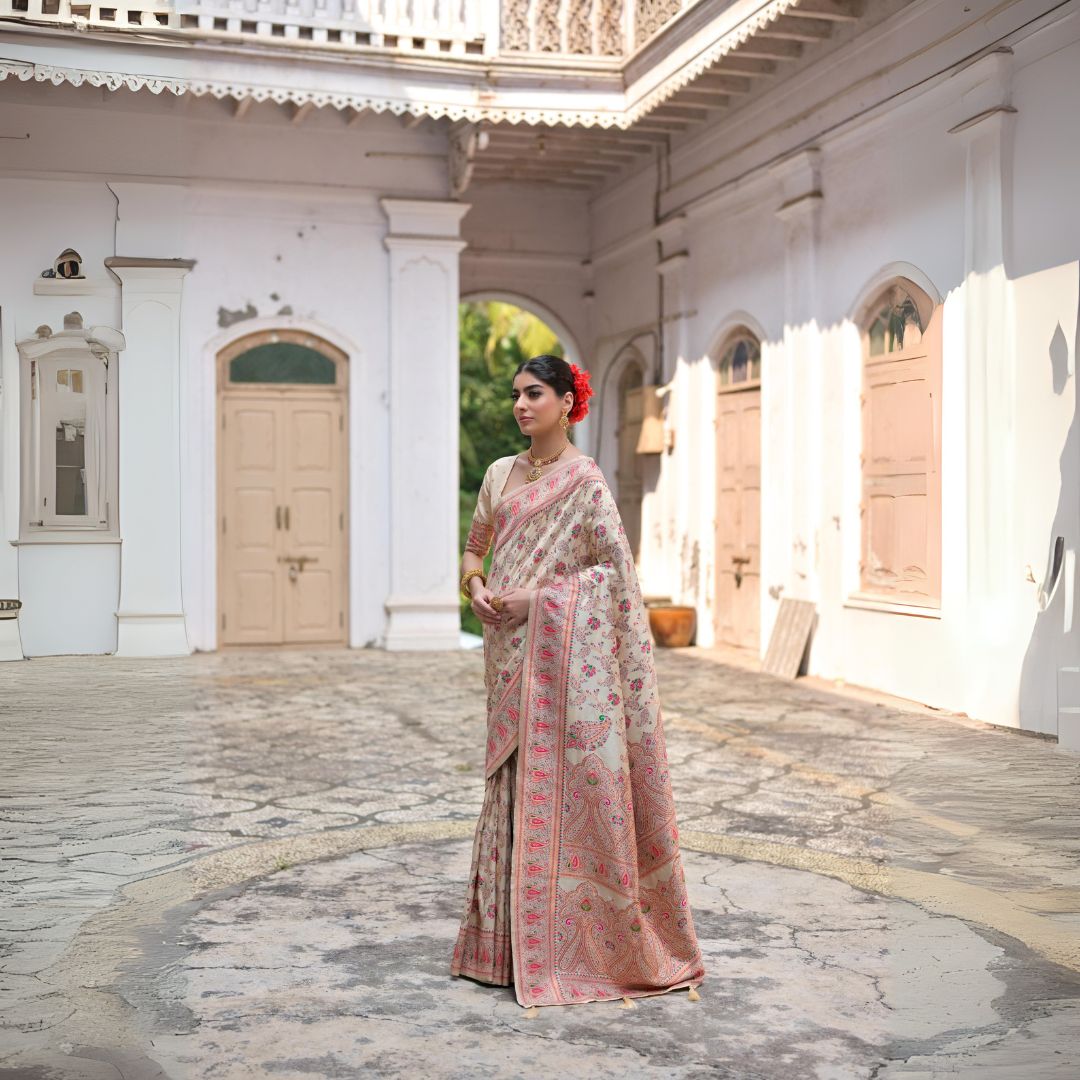Beige zari work saree with intricate traditional embroidery patterns