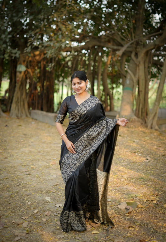 Black saree with zari work in an outdoor setting