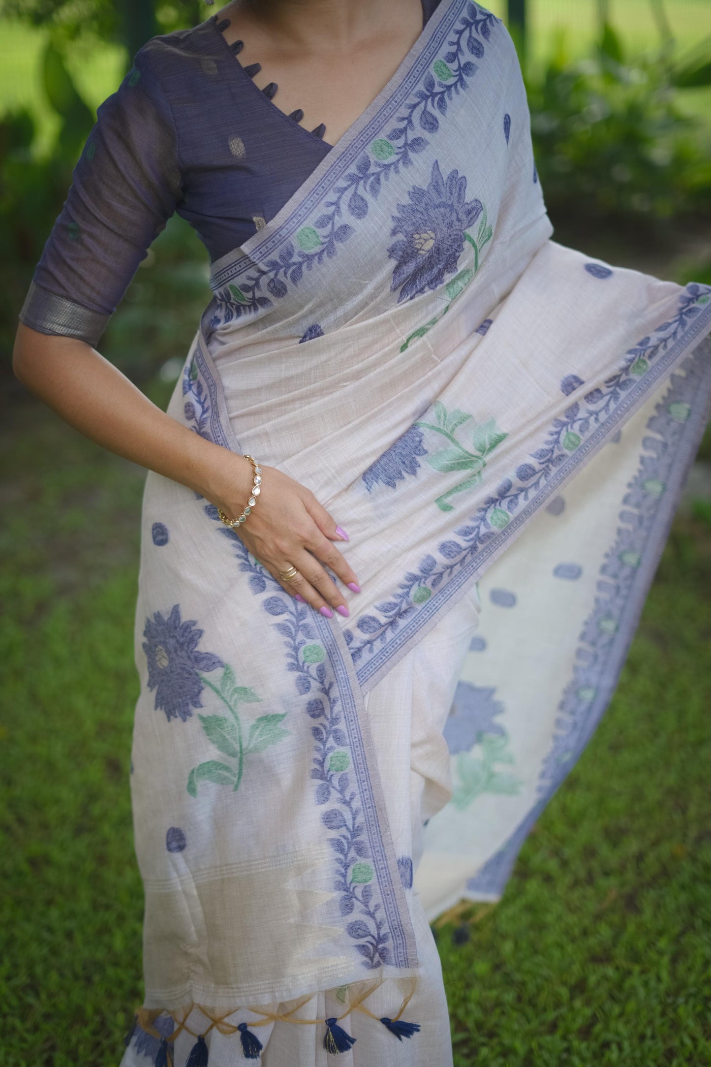 Close up of blue resham weaving saree showcasing floral design and intricate border detail on soft