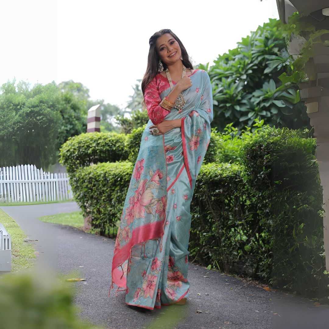 Woman wearing powder blue floral print saree posing outdoors in elegant traditional Indian ethnic outfit