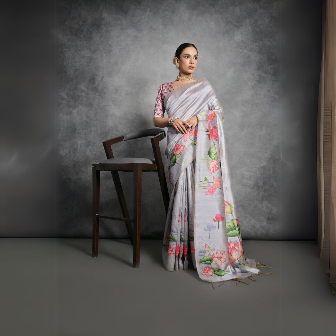 Woman wearing light gray floral printed saree posing outdoors in traditional Indian ethnic attire