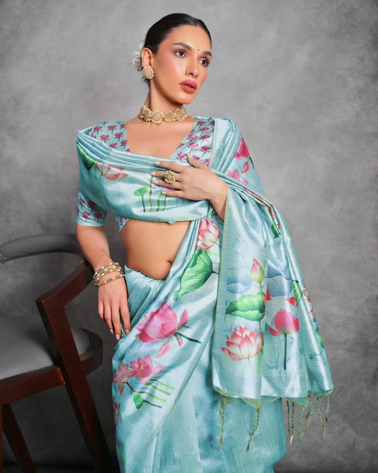 Woman wearing powder blue floral printed saree posing outdoors in traditional Indian ethnic attire