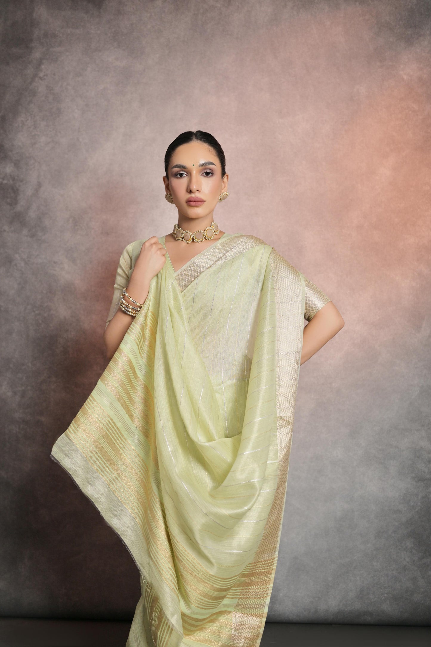 Graceful pastel pistachio green saree crafted from premium rangoli silk fabric