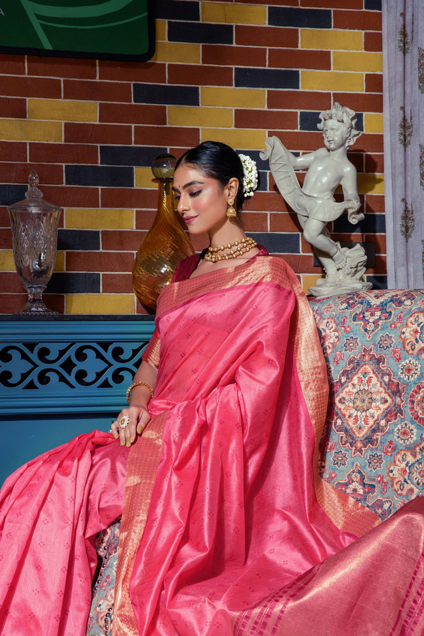 Pink saree with intricate zari work and gold border