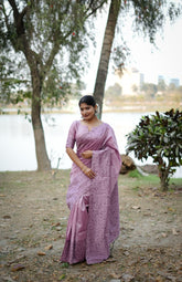 Purple saree with zari work in an outdoor setting