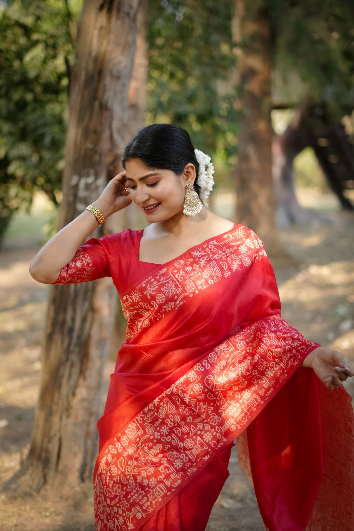 Red saree with intricate zari work close up