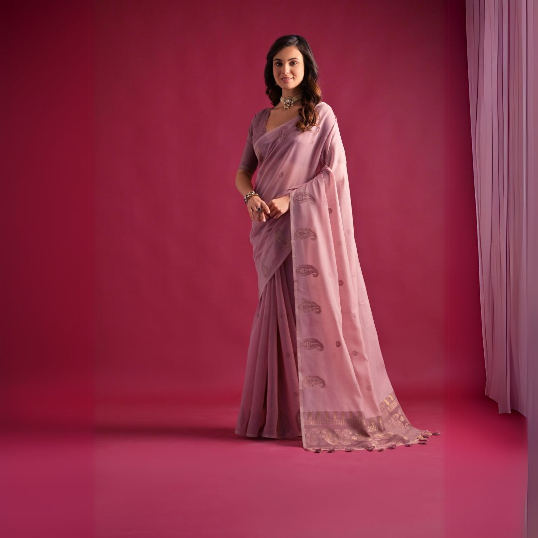 Woman wearing soft pink Resham weaving saree posing outdoors in traditional Indian ethnic attire