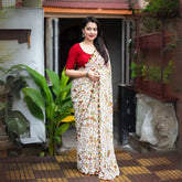 Embrace tradition with this White Warli Print Soft Georgette Saree, a stunning piece for any occasion. Crafted from lightweight soft georgette, this saree features intricate Warli prints in a classic white base, accented with vibrant multicolored patterns and a playful pom-pom border.