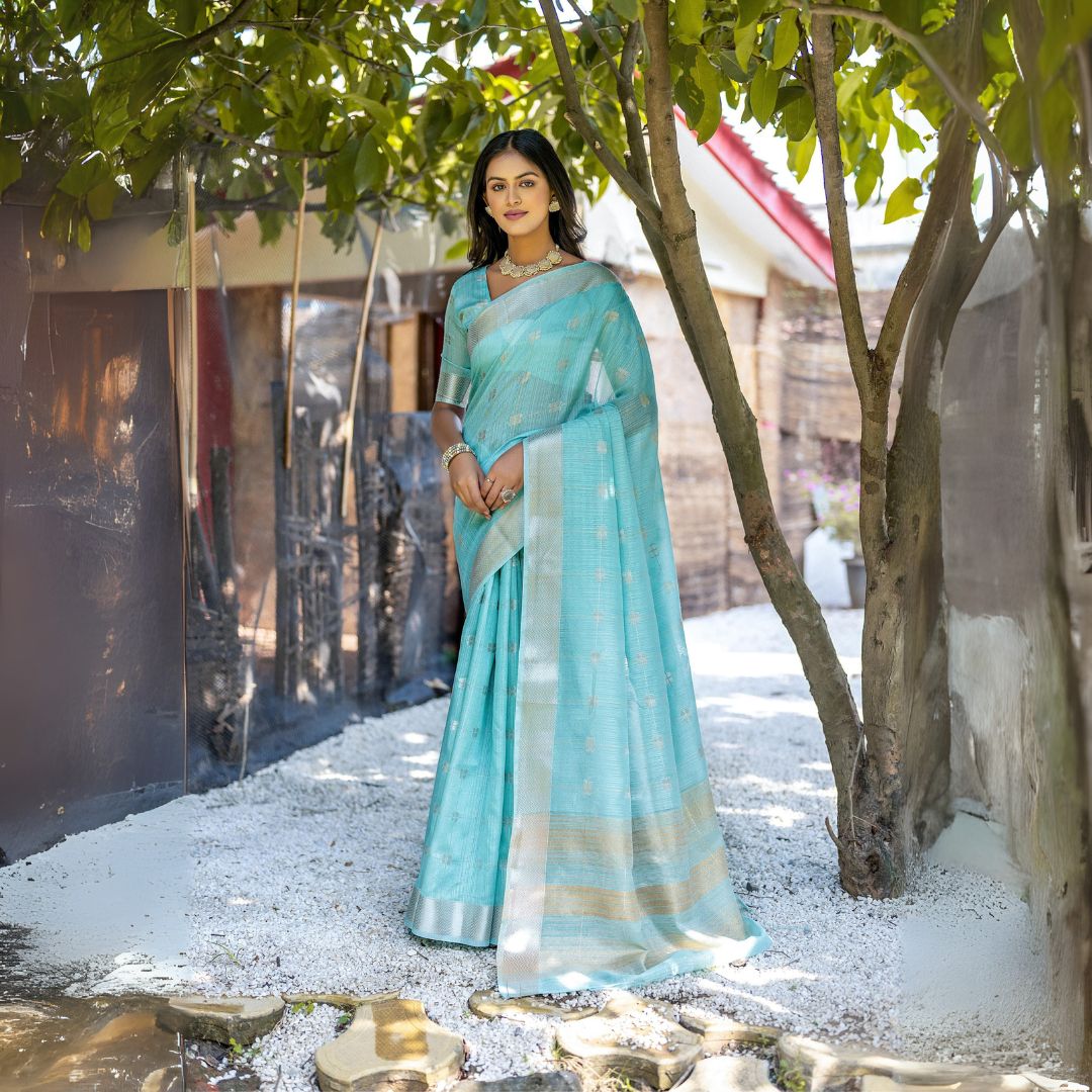 Woman wearing powder blue Zari weaving saree posing outdoors in traditional Indian ethnic attire