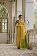 Woman in yellow and green traditional robe holding a folding fan, standing on a pavilion balcony by arched windows.