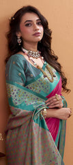 Woman wearing a traditional saree with a pink blouse against a beige background