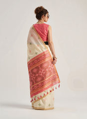 Beige Patola silk saree featuring traditional geometric and floral weaving patterns. Includes a matching blouse piece. Lightweight and elegant, perfect for festive and ceremonial wear.
