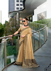 Woman in a beige saree standing on a modern balcony with a cityscape background