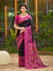 Woman wearing a black and pink saree with a garden background