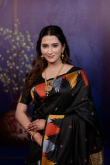Woman in a traditional saree with a colorful design against a dark background