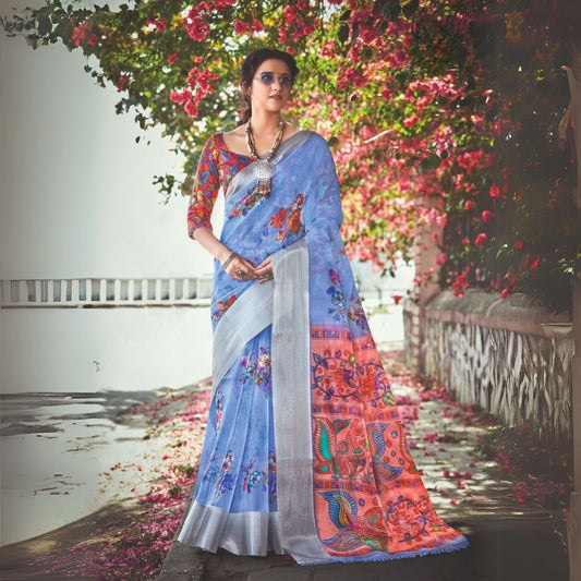 Woman wearing a blue gray floral print saree named Delight Dream WH12 by Shreyans Fashion with vibrant background flowers