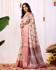 Woman wearing a floral saree with a pink border against a white curtain background