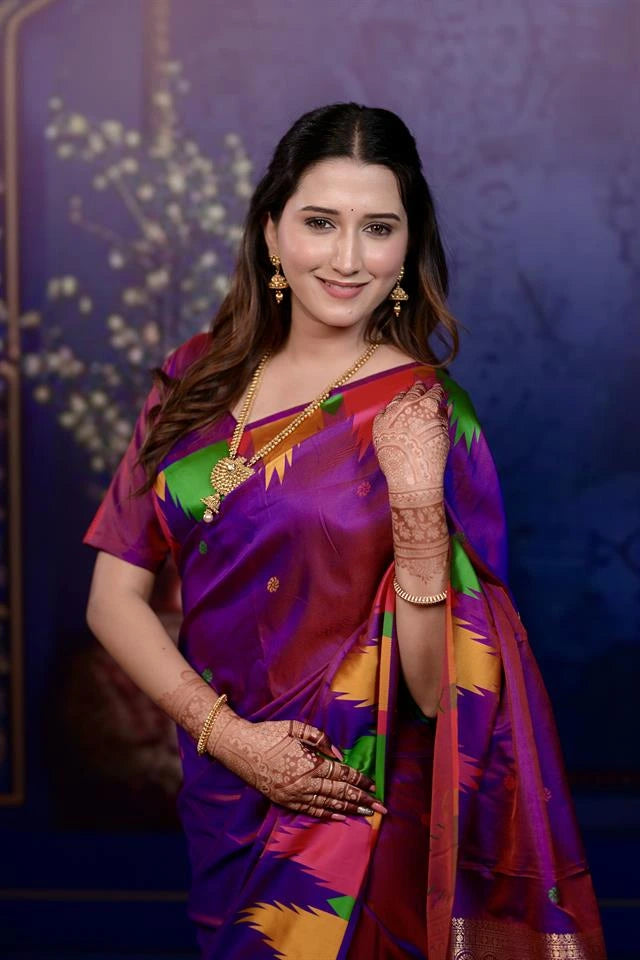 Woman in a colorful saree with a decorative background