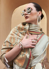 Woman wearing a patterned scarf and sunglasses with a neutral background