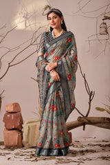 Woman wearing a floral saree with a neutral background