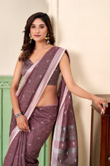 Woman wearing a purple saree with a white background