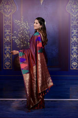 Woman in a traditional saree with a decorative background