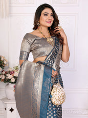 Woman wearing a silver and blue saree with a white background