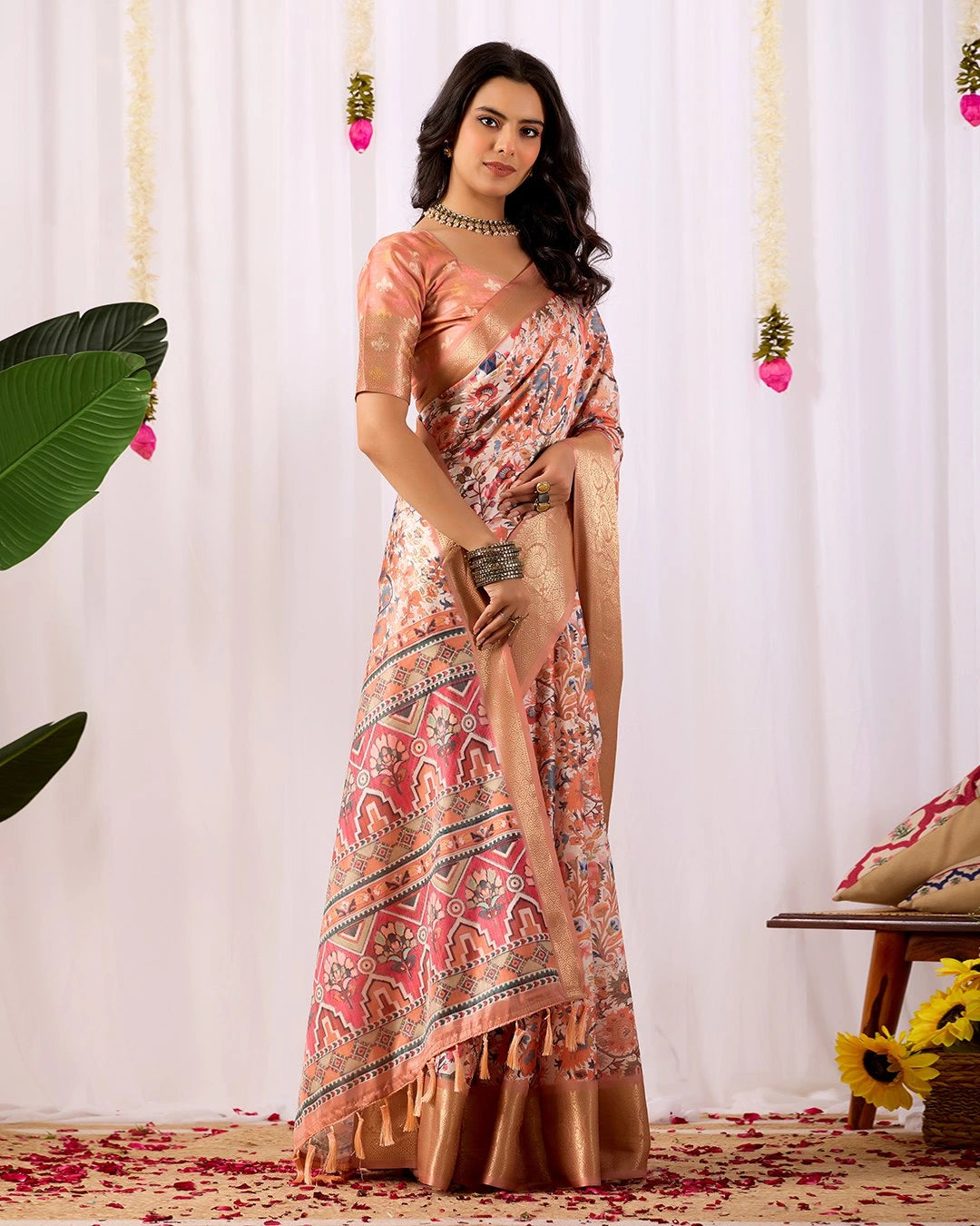 Woman in a floral saree with a white curtain background