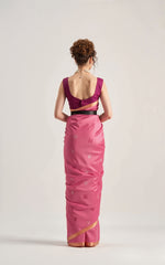 Woman wearing a pink saree with a cut-out design on a white background