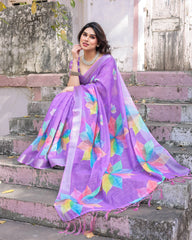 Woman wearing a colorful saree with a floral pattern on steps.