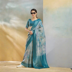Woman wearing a blue saree with a gradient effect against a neutral background