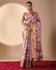Woman wearing a floral saree with a gold border on a beige background