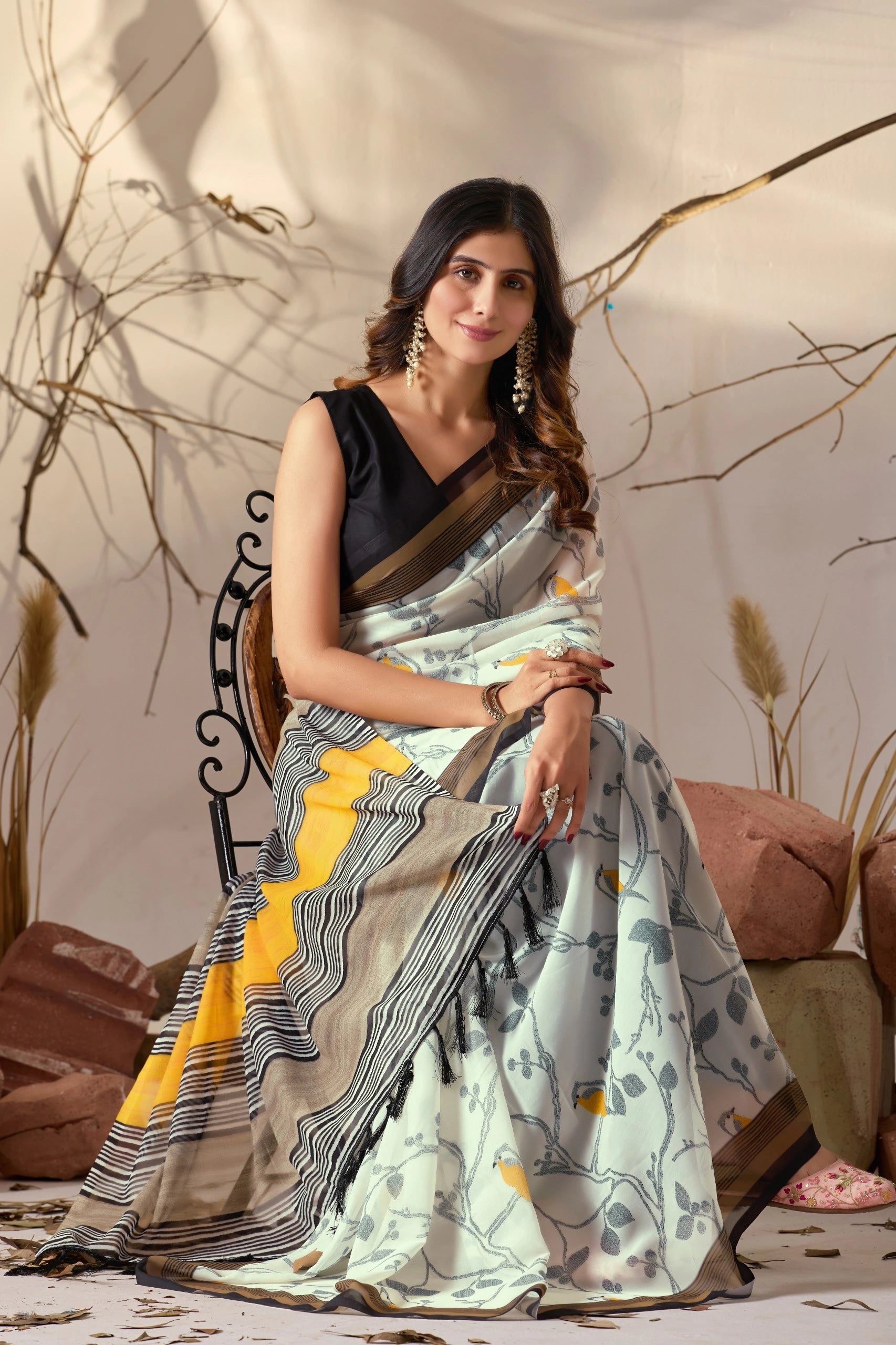 Woman wearing a saree with a floral pattern in a decorative setting