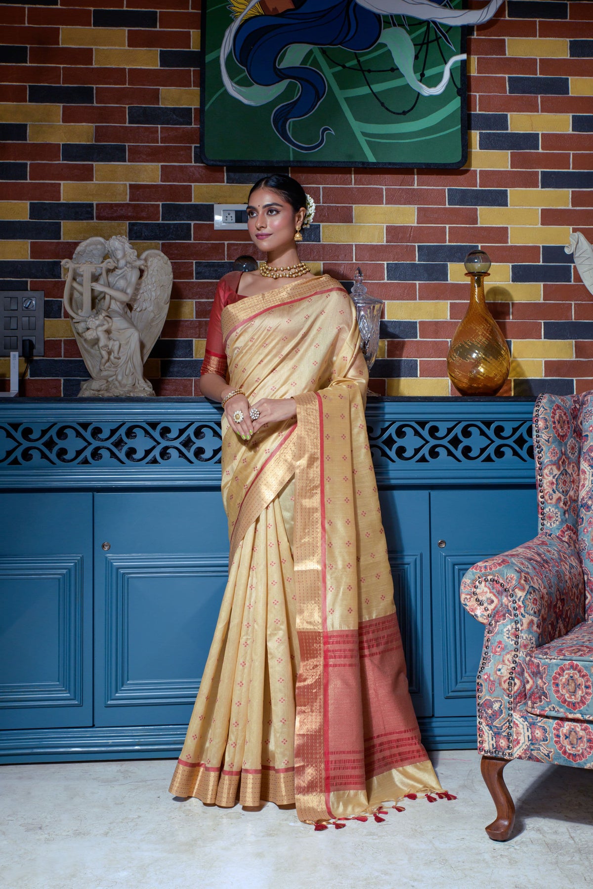 Beige saree with zari work and red border