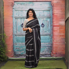 Woman wearing a black Jaipur block print saree with intricate white motifs, paired with printed blouse