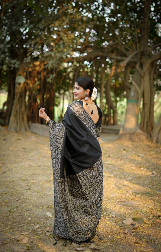 Black saree with zari work design seen from behind outdoors