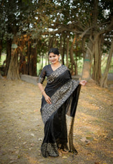 Black saree with zari work in an outdoor setting