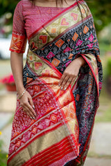 Woman wearing a blue saree with intricate zari work, standing gracefully in an outdoor setting