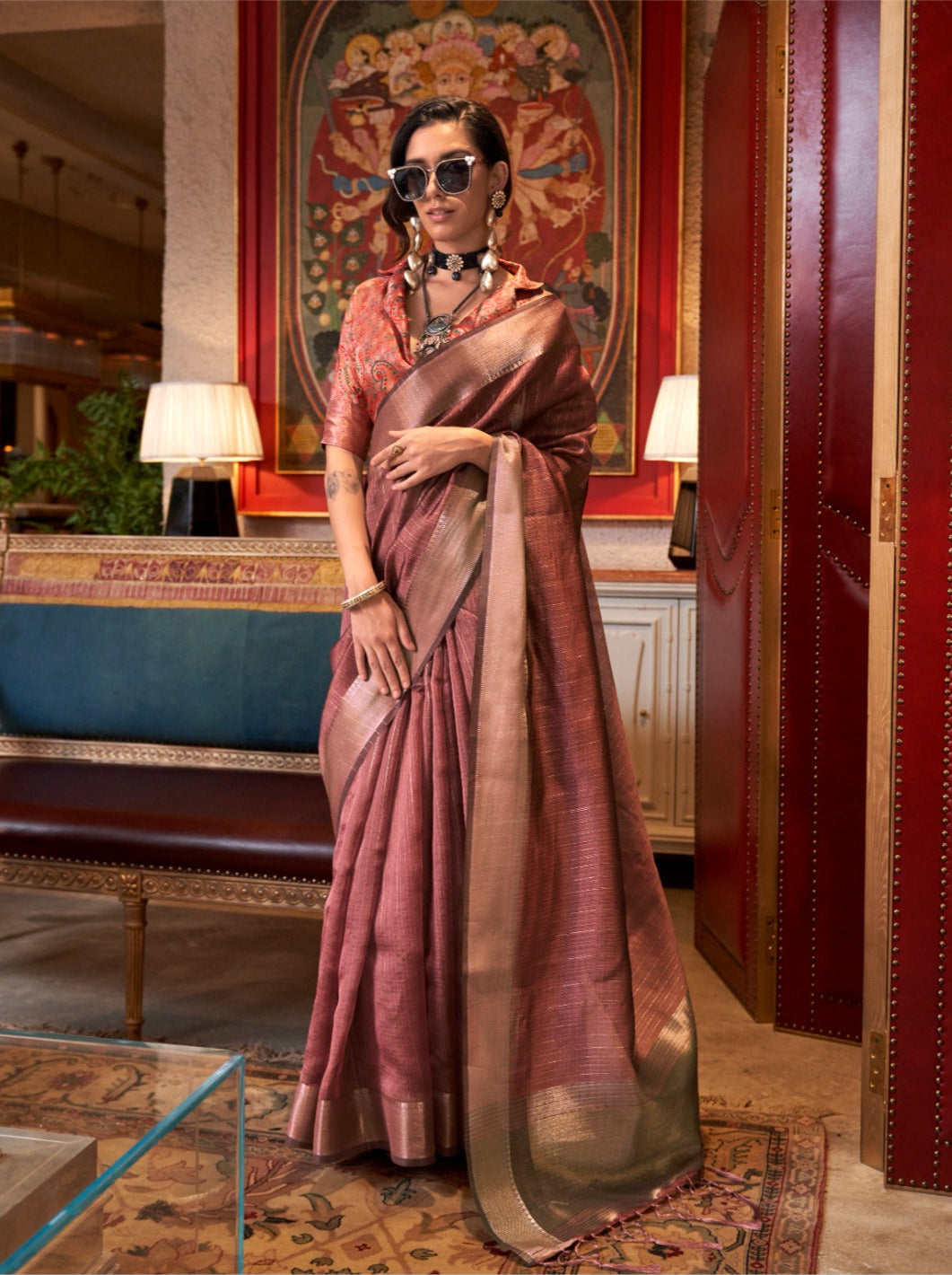 Woman in dark pink zari work saree with embroidered blouse and statement jewelry showcasing modern ethnic fashion