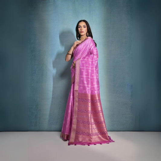 Deep pink saree featuring intricate ikkat and zari weaving, showcasing traditional handloom textile craftsmanship