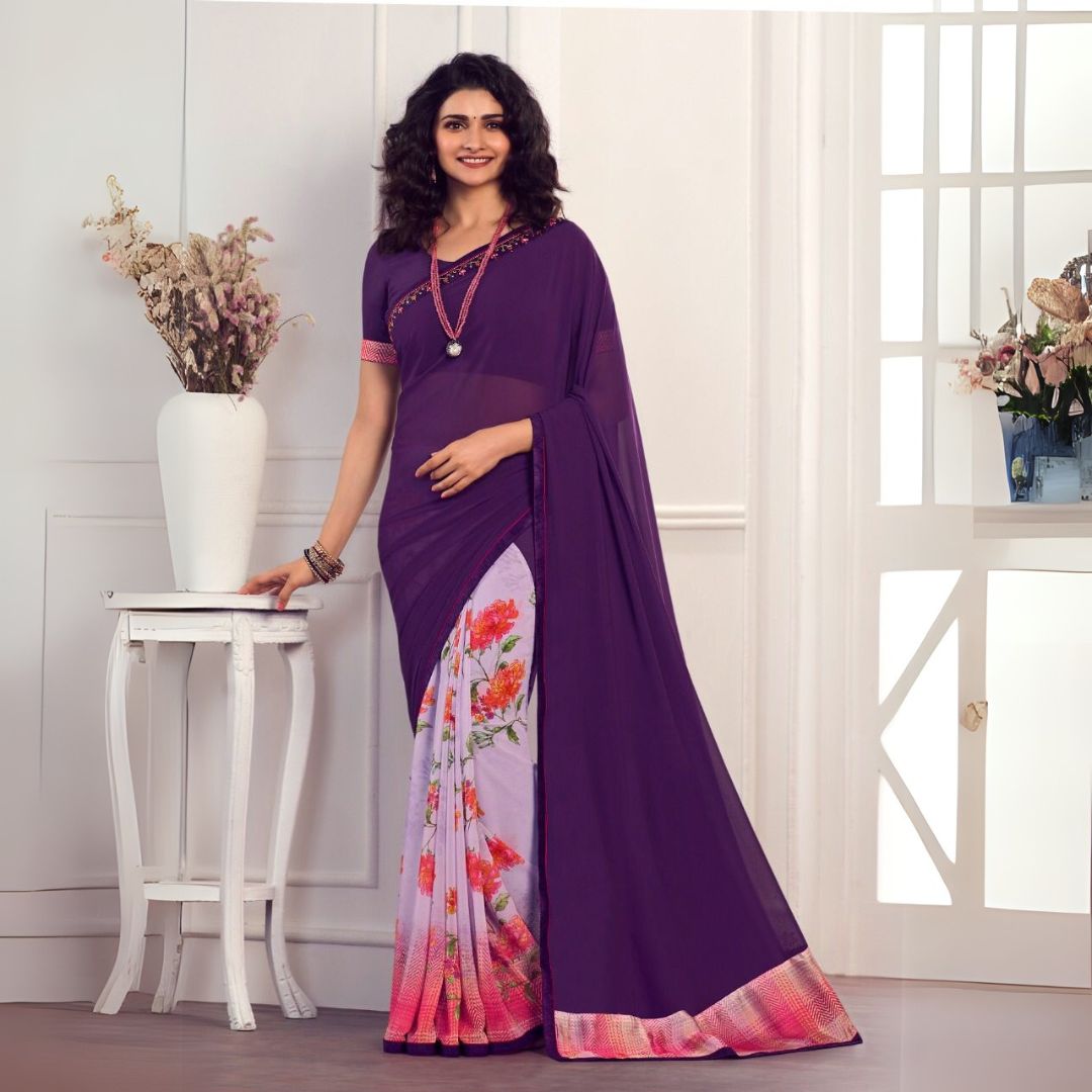 Woman wearing deep purple printed saree with floral patterns and pastel border in a graceful traditional setting