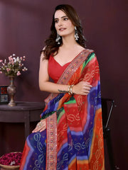 Woman wearing a colorful saree with a red blouse against a dark background